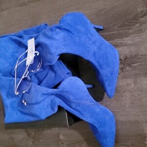 Elegant Blue Knee-High Stiletto Boots Tossing In The Gold And Blue Shades.